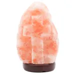 Himalayan pink salt lamp with carved cross on wooden base