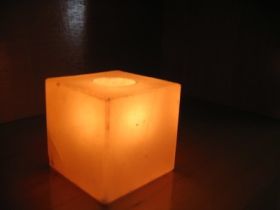 Square geometric Himalayan salt candle holder glowing